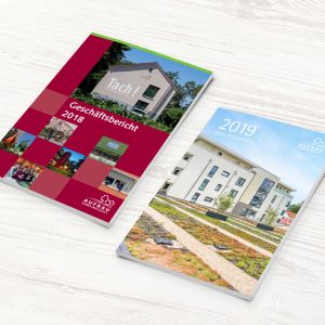 Alter und neuer Geschäftsbericht der Aufbaugemeinschaft Espelkamp nebeneinander